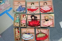 Top view of all 10 Wendy dolls neatly arranged in their original display boxes, showing a variety of colorful ethnic costumes.