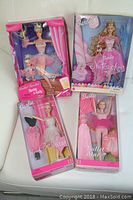 Four boxed Barbie dolls shown together: Nutcracker Barbie, Ballet Recital Barbie with Kelly, and two Ballet Star Barbies. All boxes are sealed showing dolls and accessories clearly.