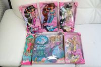 Photo of all Barbie dolls arranged on white couch, showing original pink packaging and clear fronts, highlighting Splash n Color, Jewel Hair Mermaid, and Magical Mermaids dolls.