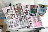 Boxed My Fair Lady Barbie dolls and Ken doll on white couch showing all dolls packed with promotional packaging