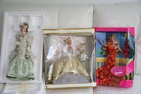 Full view of all three boxed Barbie dolls showing packaging and details.
