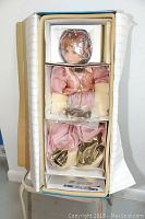 Photo of boxed doll showing the entire doll in original packaging with protective styrofoam.