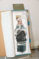 Porcelain doll in original packaging, showing the full doll in box with foam and wrapping.