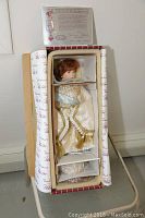 Porcelain doll Anastasia in original box with visible Certificate of Authenticity at top.