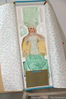 Porcelain doll named "Paradise" by Rustie in original box, showing full doll wrapped securely with tissue paper and certificate of authenticity visible.