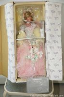 Porcelain doll in original box with protective plastic and tissue paper with brand name Rustie on tissue paper.