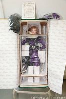Porcelain doll 'Pearl' in original box, protected by plastic and foam, with certificate above