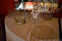 Photo of the glassware set including pitcher, decanters, ice bucket, and golf-themed glasses on a table.