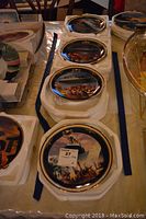 Four Bradford Exchange commemorative Titanic plates stacked with protective boxes