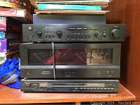 Three stacked Hitachi audio components: HCA8500 amplifier, HMA8500 power amp, FT5500 tuner