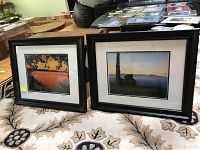Two signed framed photographs side by side on a carpeted floor showing both images and frames.