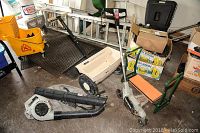 Photo showing Ortho seeder with white hopper, Craftsman leaf blower in black, and Craftsman automatic blade rake with black handle.