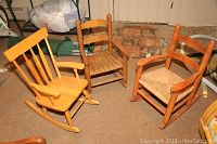 Photo of all three child size rocking chairs grouped together on floor, showing variations in wood finish and seat type