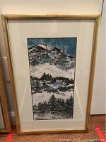 Framed mountain landscape artwork by Frank Spink in gold-toned frame with white mat.