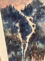 Close-up of watercolor painting showing blue mountainous landscape with textured patterns.