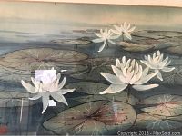 Close-up of watercolor painting showing white water lilies and lily pads on water surface.