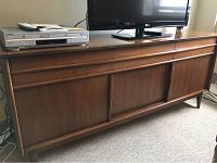 Front view of hardwood media console with TV and electronics (not included) on top