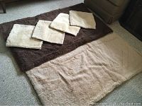 Full view of the reversible two-tone llama wool blanket and four matching reversible llama wool pillow covers laid flat showing colors and size.