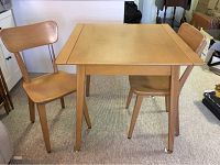 Front and side view of the maple dinette table with 2 chairs showing the table top surface and chair design