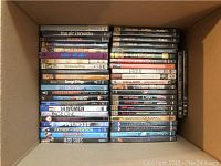 Box with DVDs showing titles such as 'The Air I Breathe', 'Hawa', 'Borough of Kings', '14 Women', 'Page One','Poliwood','Father of Invention','Good Dick'