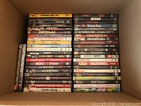 Overhead view of DVDs in a box showing a variety of titles stacked vertically
