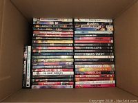 Box showing various DVD cases stacked with visible titles such as 'Happy Thank You More Please', '8 Mile', 'Heaven on Earth', 'Dark Matter', 'Fatal Love', and others.