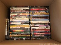 Box of DVDs showing titles Wonderland, The Prize Winner of Defiance Ohio, On Their Knees, Wedding in White, Donkey Punch etc.