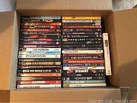 Cardboard box containing two tall stacks of music DVDs, view from above