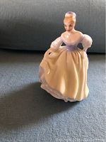 Side view of the Royal Doulton Fair Lady figurine showing detailed dress and figure.