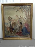 Full view of framed tapestry showing central scene of women under palm trees