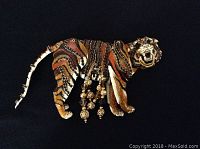 Front view of enamel tiger brooch showing detailed enamel and bead work with dangling beaded charms.