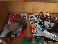 Photo of John Lennon autobiography book and 2 music magazines including one with Jim Morrison on cover