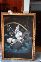 Full view of the framed velvet painting showing Pegasus and unicorn with rainbow and star details