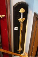 Full view of the Franklin Mint Viking sword mounted on a black plaque positioned vertically.