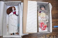 Both dolls in their original boxes with tissue paper inside, Morgan LeFay doll on the left and Little Cloud doll on the right with accessories.