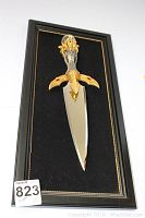 Full view of decorative King Arthur's dagger mounted in black wood shadowbox frame with velvet backing and gold trim.
