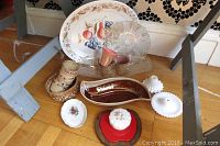 Photo showing a variety of vintage serving items including ceramic trays, hobnail glass items, a floral trinket box, and drip glaze pottery.