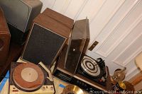 Photo of the vintage turntable, speaker pair, 8 track player cabinet, and an additional older record player