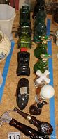 Collection of 14 vintage men's Avon collectible bottles in various shapes and colors arranged on a surface showing wear and usage.