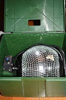 Electric disco ball housed inside open green plastic case, showing disco mirrored ball and control box with power cable.