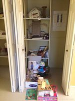 Shelving unit with various crafting materials organized including boxes, forms, and small items.