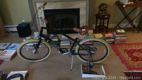 Full front-side view of black bike with brown saddle and grips, cream tires and Radical pump in foreground