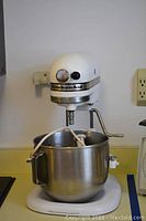 Front view of KitchenAid K5A stand mixer with bowl and attached beater on counter