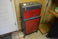 Front view of the stacked toolbox units showing the top toolbox with drawers and the lower cabinet on wheels.