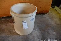 Full view of the large No. 6 crock on a concrete floor showing the overall shape and color.