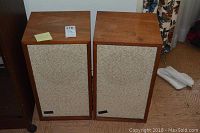 Pair of KLH Model 4 loudspeakers side by side, front view showing fabric covers and wood finish.
