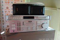 Front view of Crown FM-2 receiver and Pioneer A-70 amplifier stacked with pair of Optimus Pro 7AV speakers on top