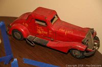 Front three-quarter view of red fire chief car on table
