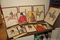 Full view of all 10 art pieces laid out, including 4 Frederic Remington prints and 6 Native American style portraits.
