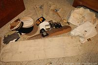 Wide view of collection showing shirts, jackets, hats, gloves, epaulets, belts, and patches.